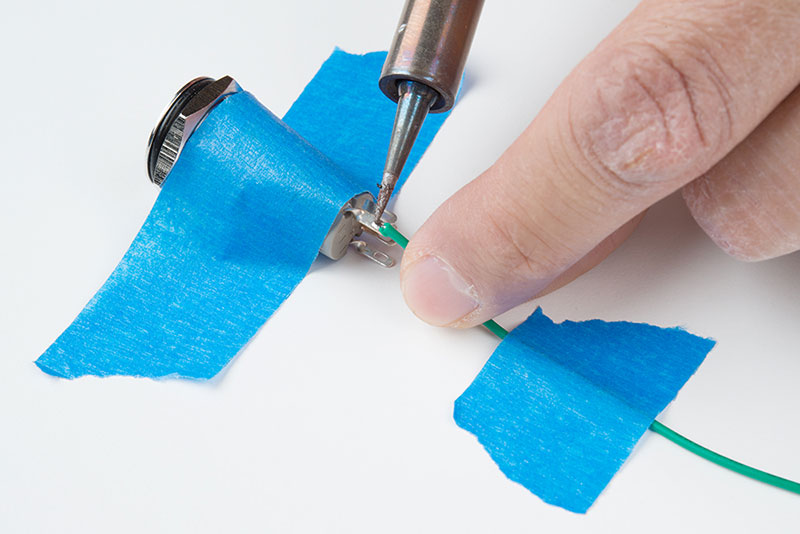 Exposed wire threaded/soldered to pushbutton&rsquo;s pin