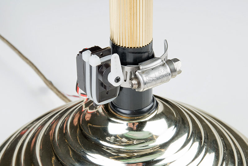 Using a screw, attach a servo arm to the servo&rsquo;s shaft