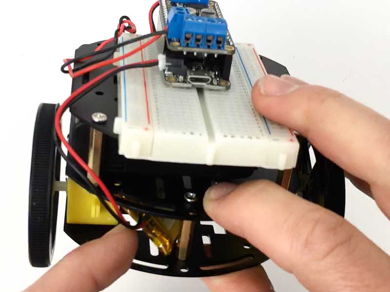Tuck battery into space in lower level of robot